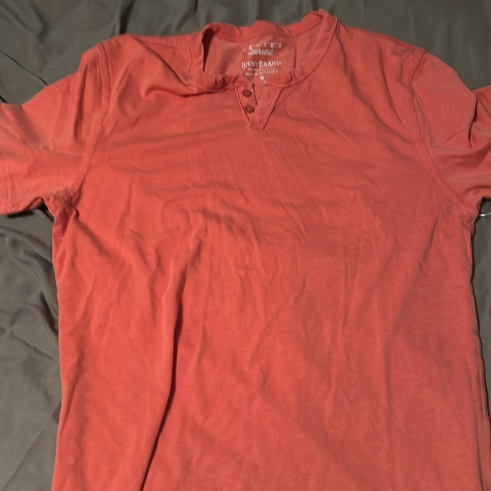 New orange medium Lucky Brand Henley short sleeve shirt with tag still on.